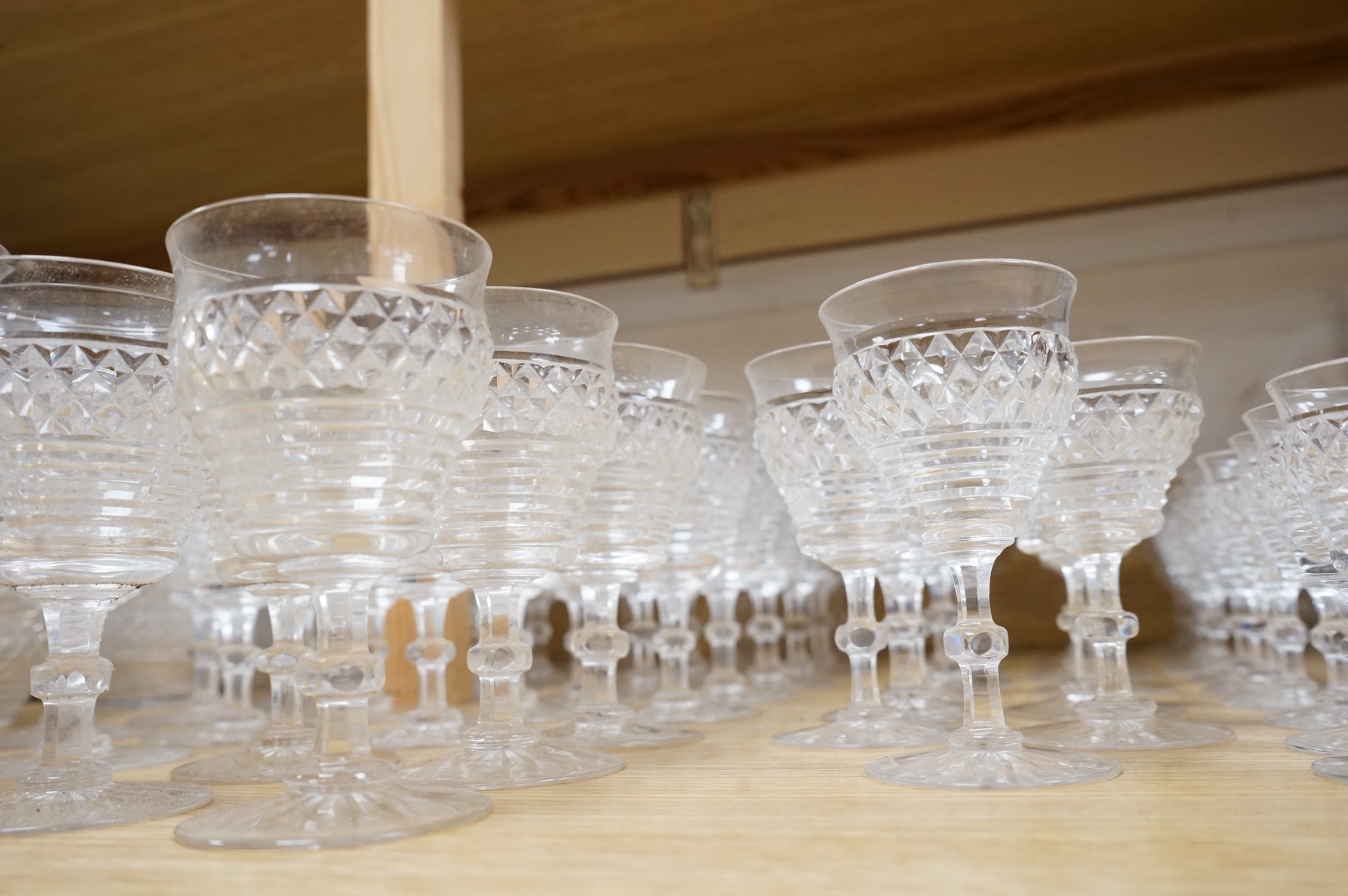 A suite of early 20th century cut table glass, custard glasses, a tall stemmed etched glass, etc., etched glass 24cm high